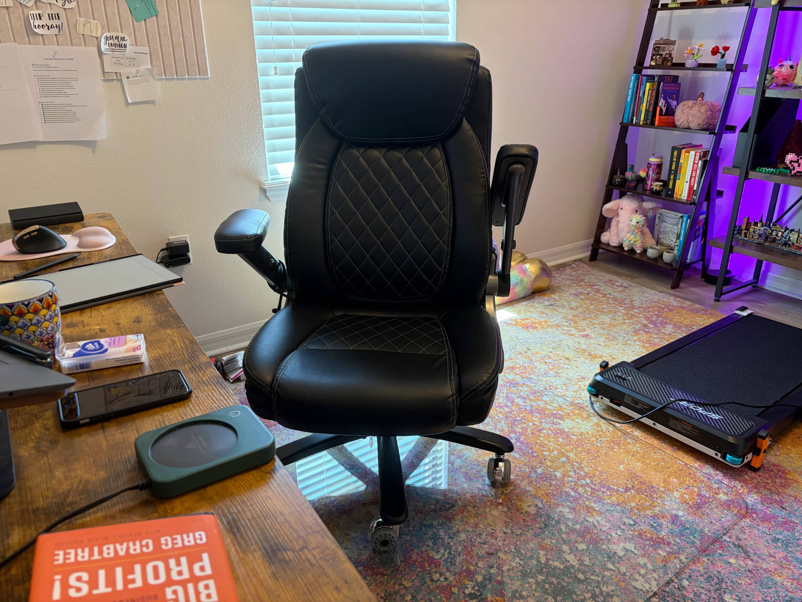 Office chair with one armrest flipped up and one armrest down showing adjustability