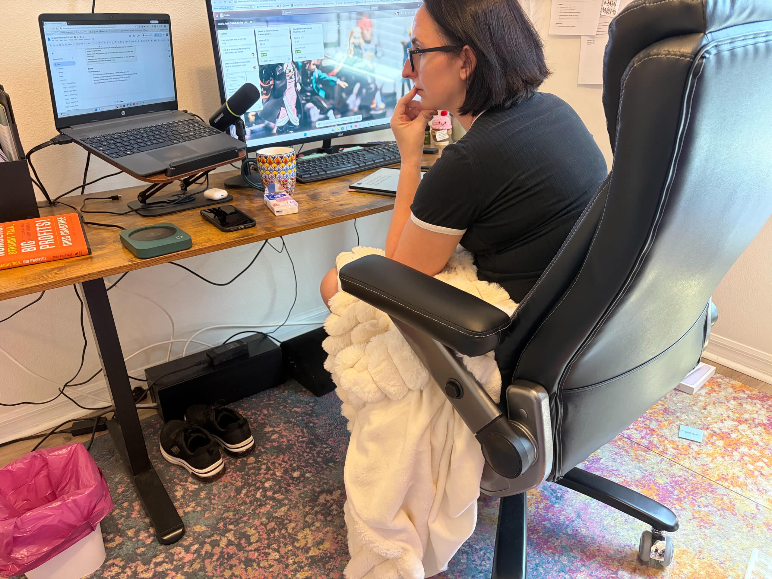 Working in a high-back executive office chair at a home office desk